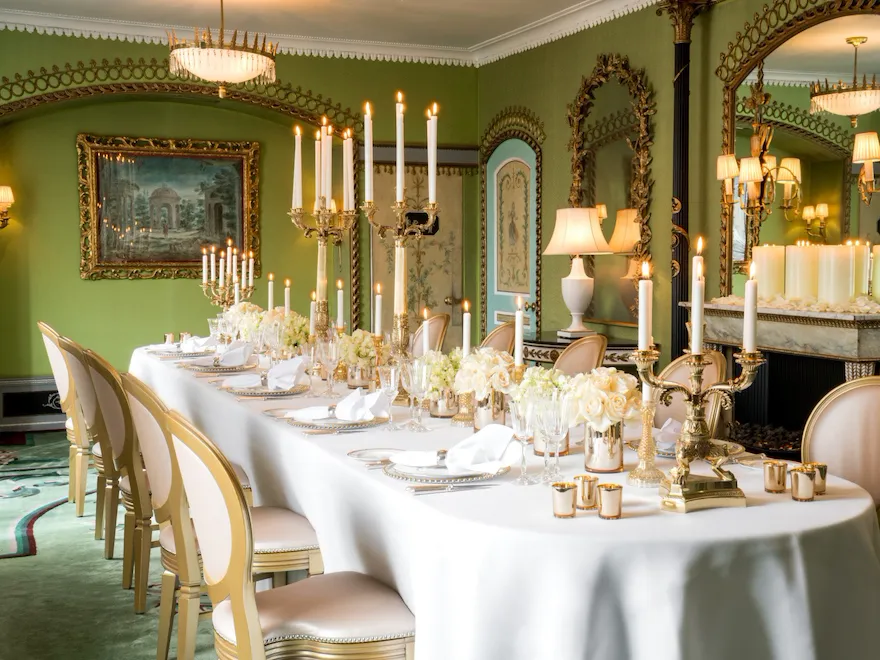 The Dorchester-Pavilion set up dinner with white flowers down the table and cut crystal glassware with candelabras