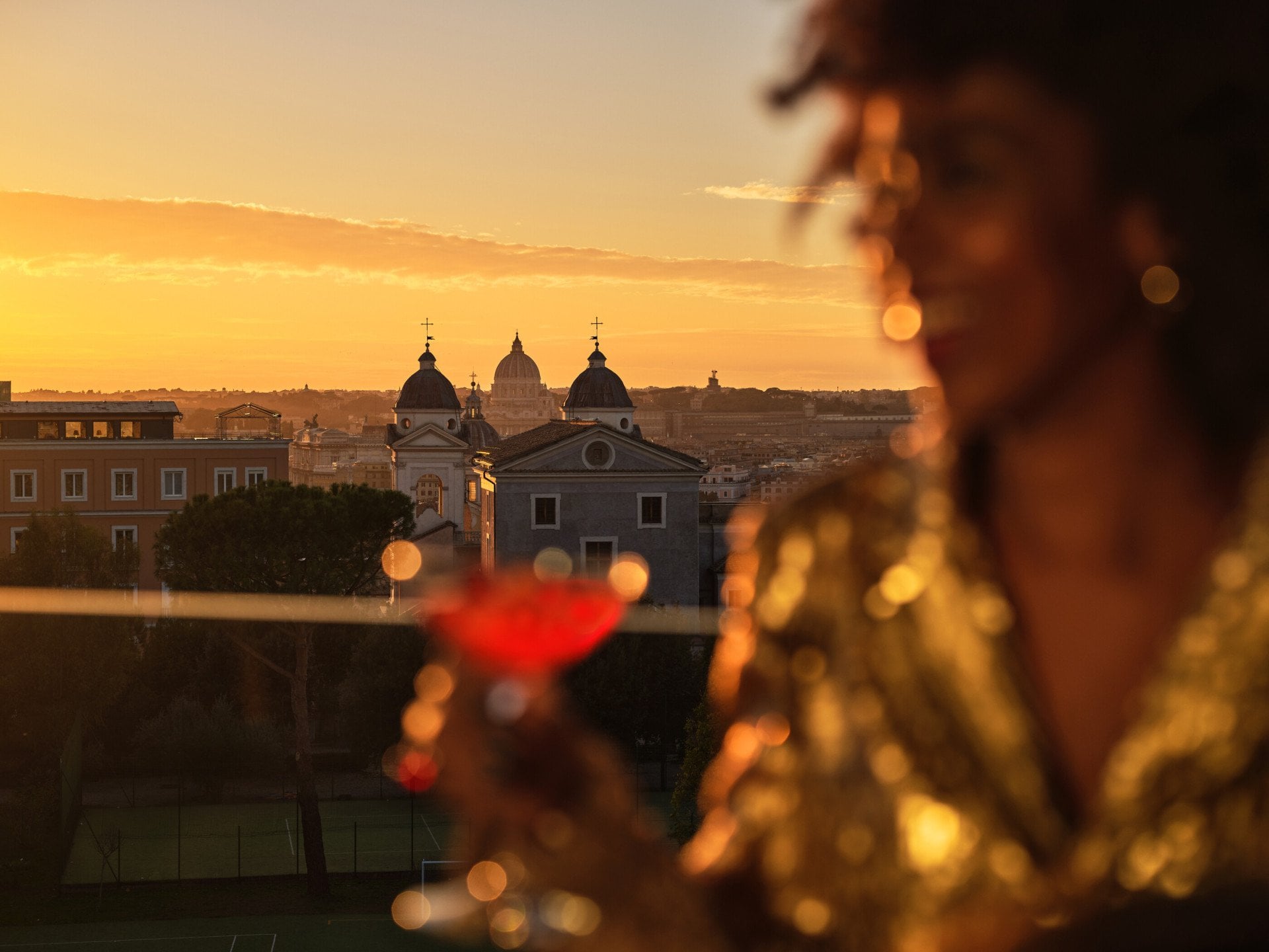 Girl having a drink and city view on background 