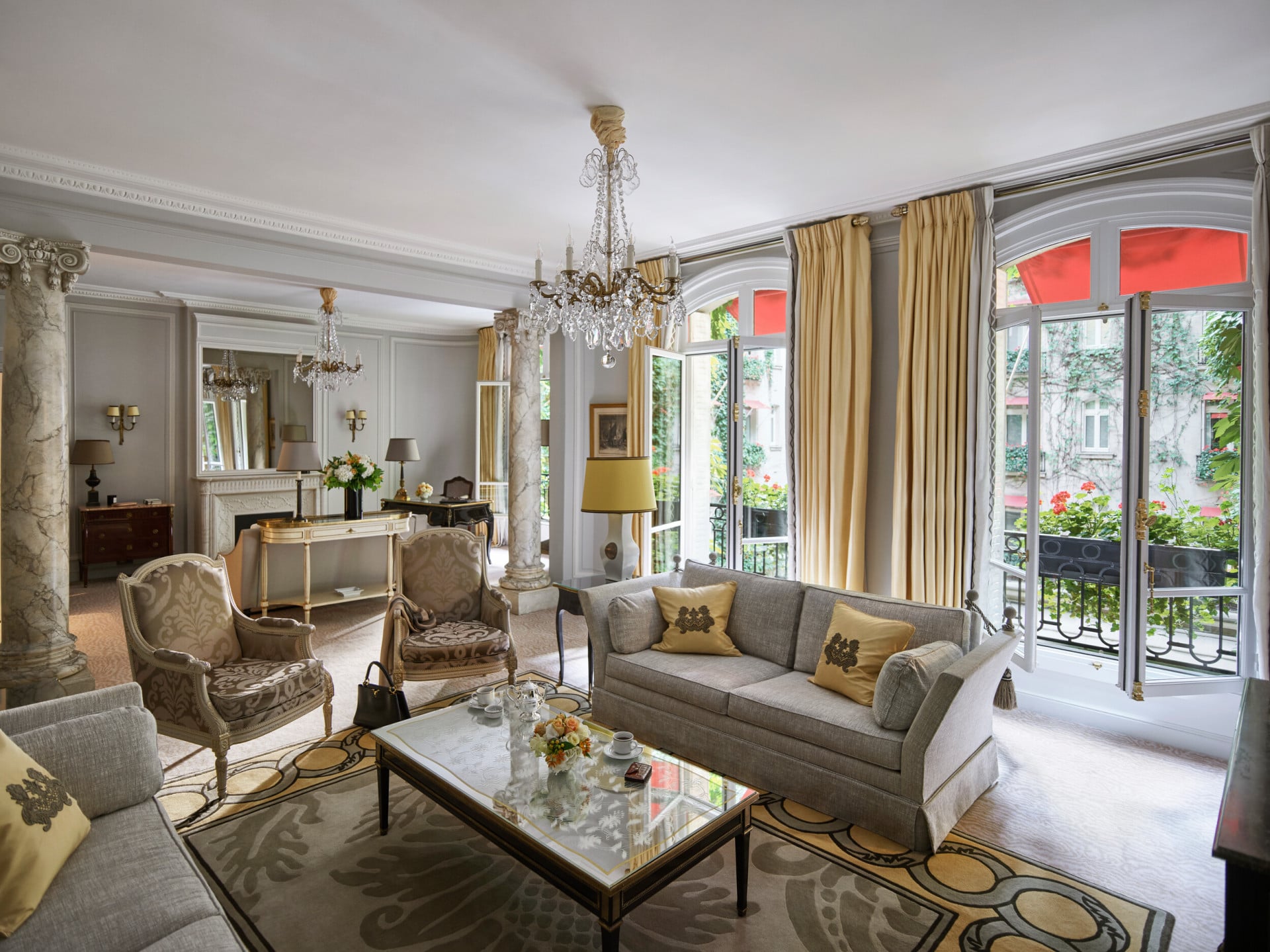 Fotografia da sala de estar da suite presidencial com vista para o jardim do pátio, no hotel Plaza Athenee