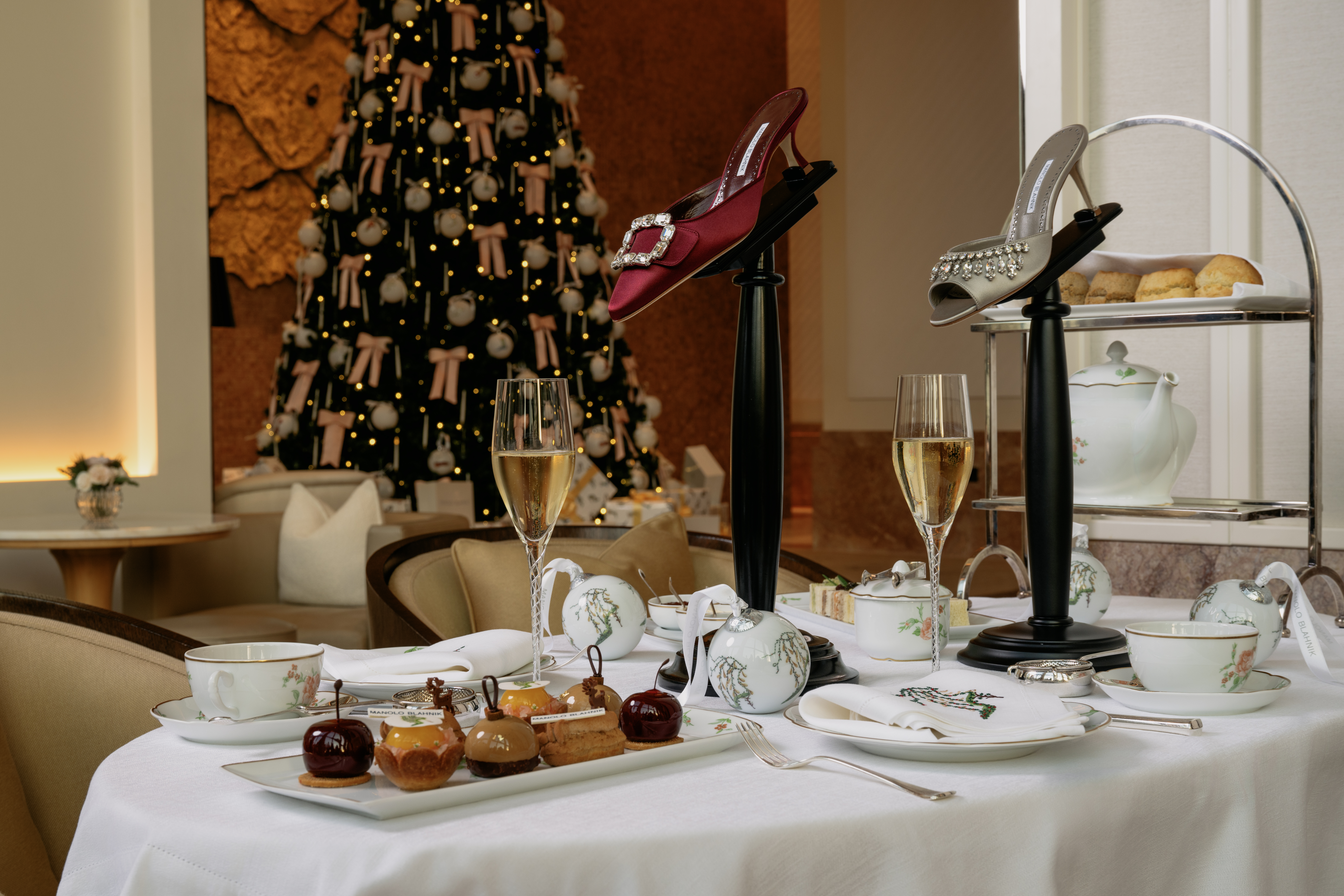 A close up of The Gallery's afternoon tea with the Christmas tree in the back