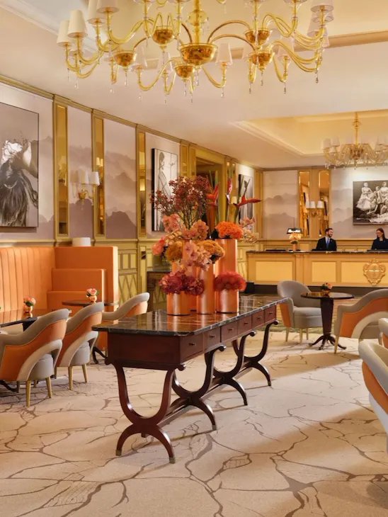 A view of 'Il Salotto’ with its characteristic orange, grey and ivory colours. The reception desk is in the background.