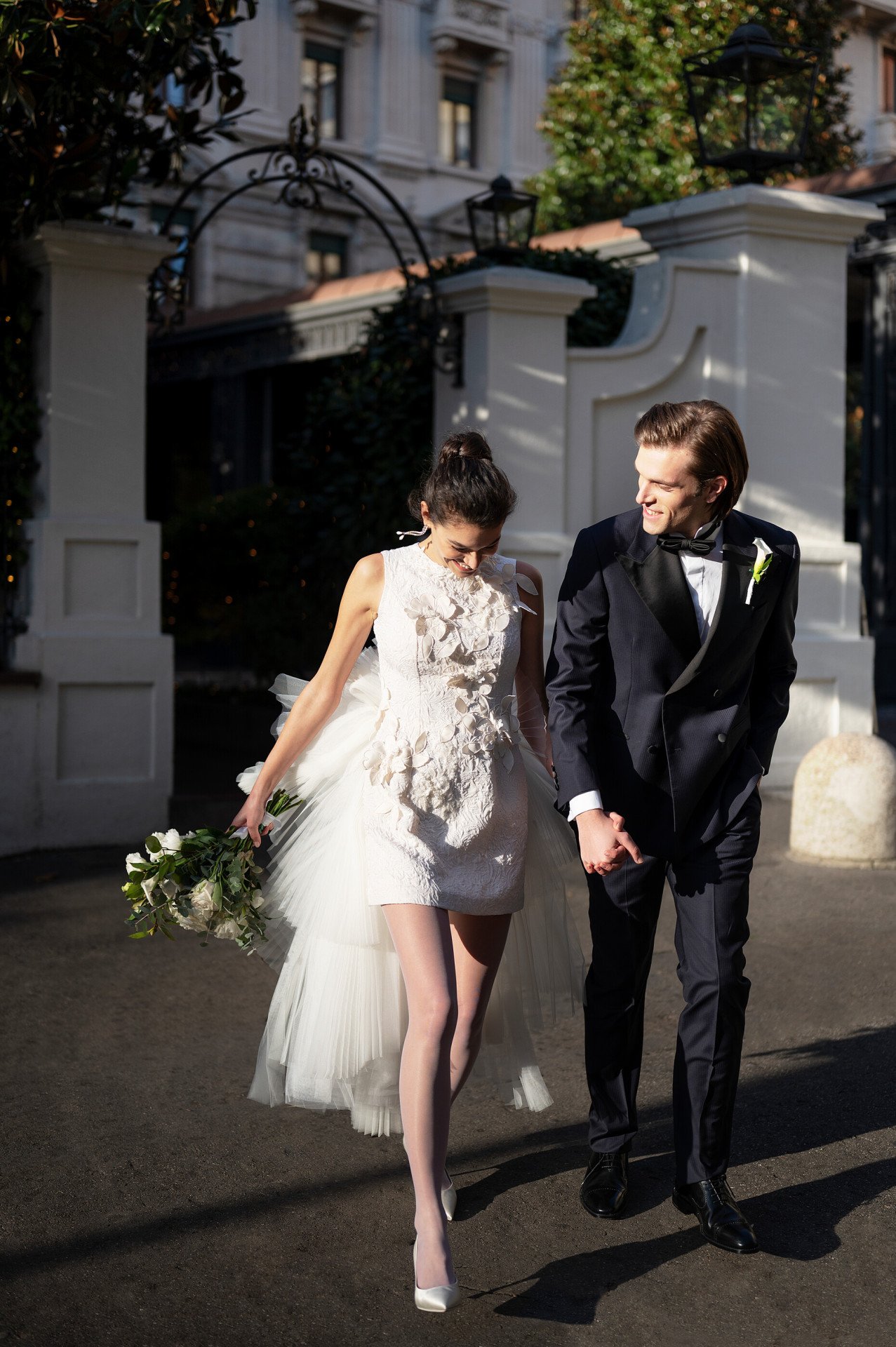Couple outside in front the facade entering the hotel