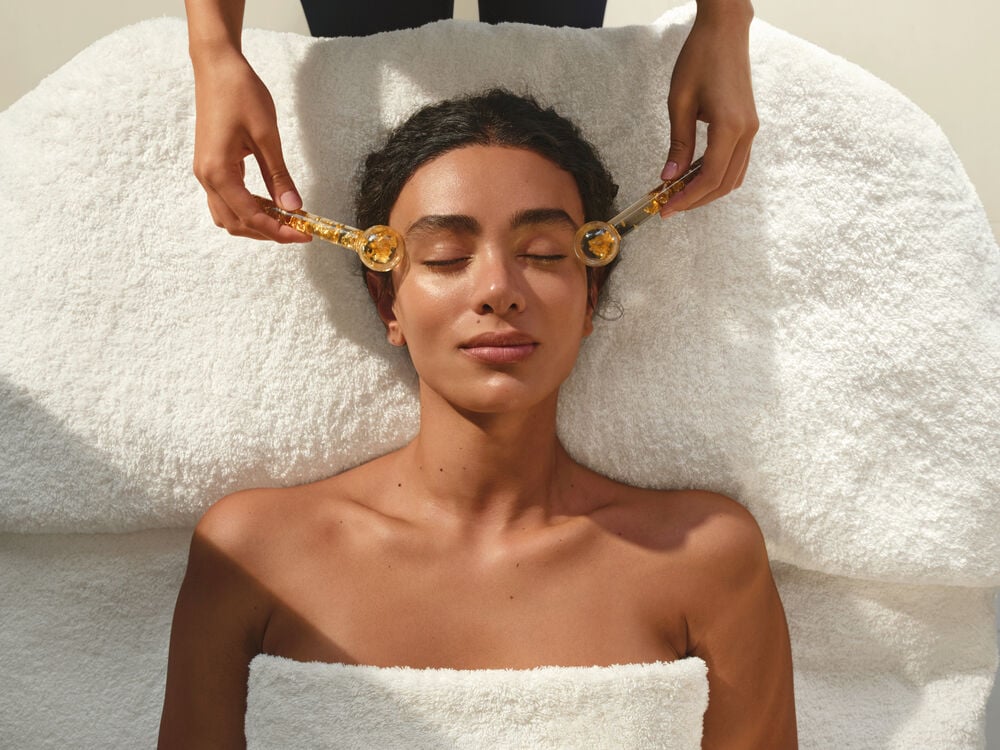 Person having Spa Treatment Facial with Ice Globes 