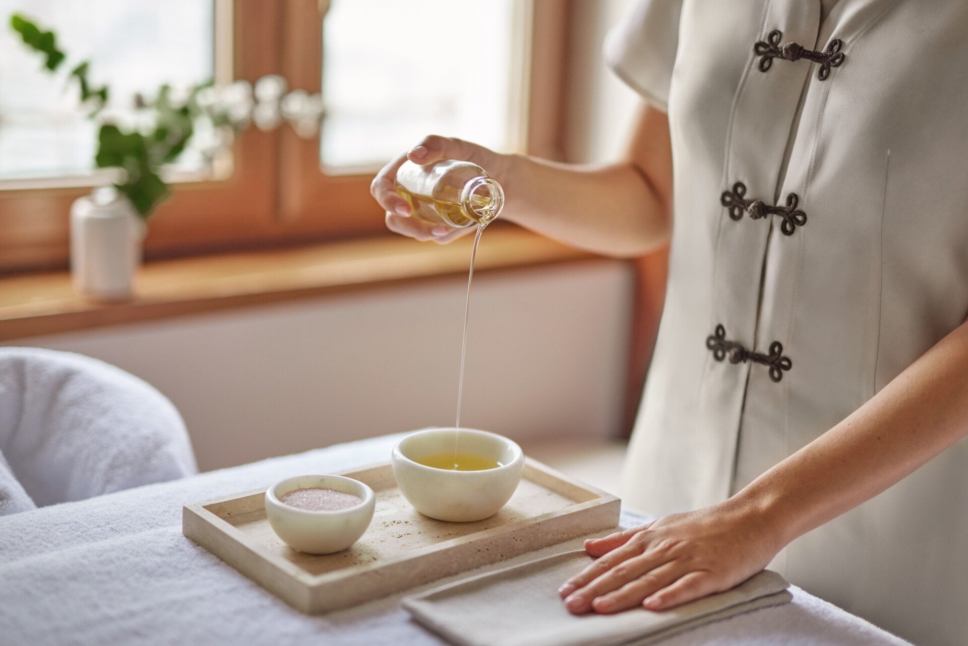 spa attendant preparing massage supplies