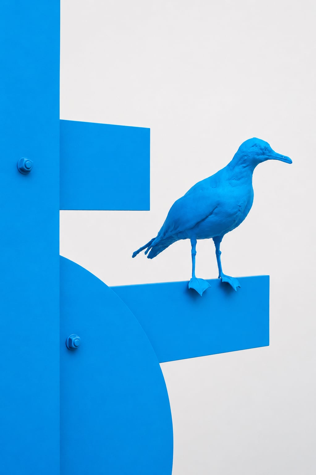 Artist, Nathan Mabry's blue sculpture of a bird perched on a structure. 