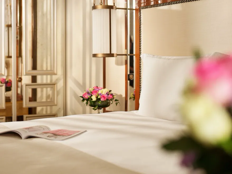 Close up on bedroom of prestige room, headboard with peacocks, night tables with flowers, at Hotel Eden, Rome
