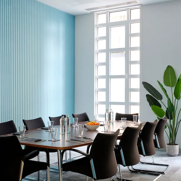 Meeting room with blue wall in Dorchester Collection Academy