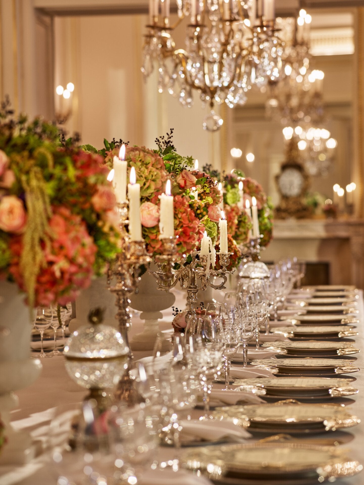 Dinner captured with details with gold and white tableware, pink and green flowers, green cakes at Le Salon Organza, at Hôtel Plaza Athénée, Paris - Dorchester Collection.