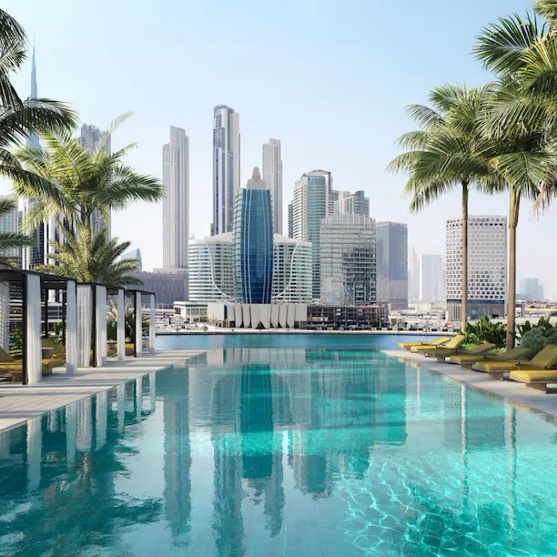Swimming pool with palm trees with view of city from The Residences Dubai
