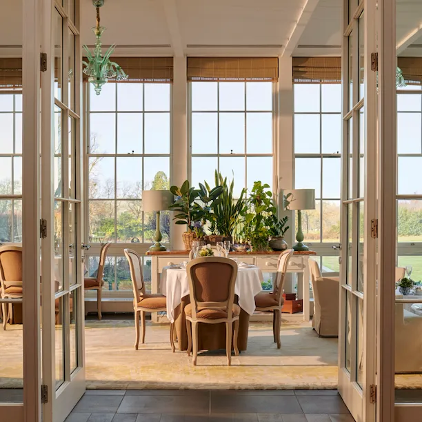 Open glass doors leading to a set up table in the central portion of the image.