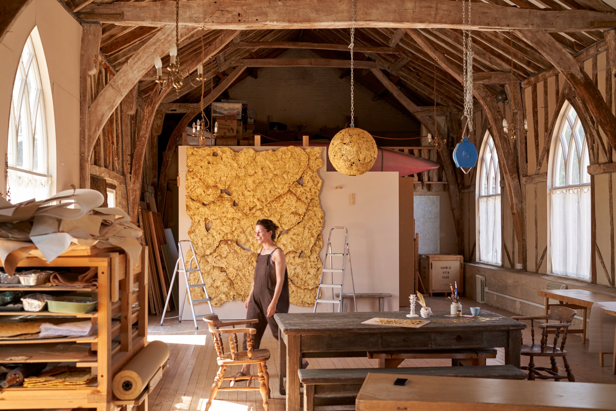 Sophie Coryndon artist in her studio in front of 'The Dorchester Dossel' artwork 