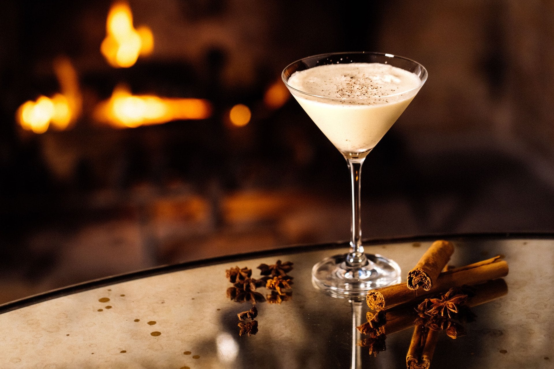 Eggnog martini on table with cinnamon sticks from the festive drinks menu in the Bar and Lounge at Hotel Bel-Air. 