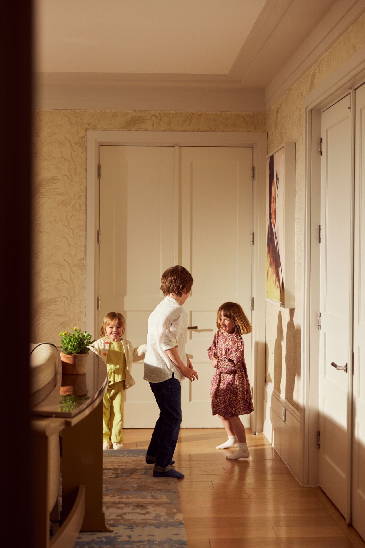 family relaxing and playing in room at Coworth Park