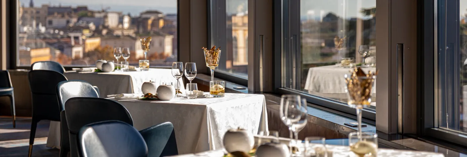La Terrazza with festive table decorations and view of Rome at Hotel Eden