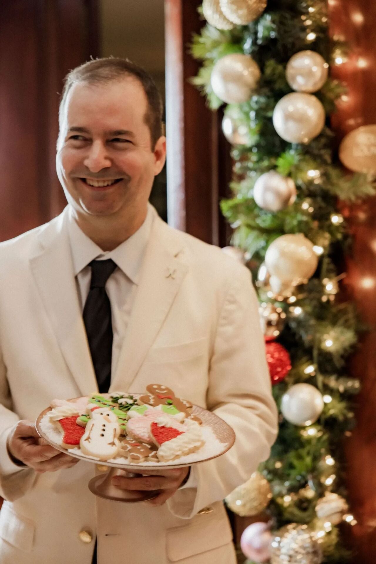 Server holding cookie display from festive cookie decorating class