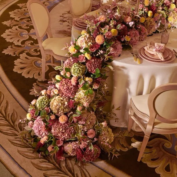 The Dorchester Gold and Silver event space set of fabulous evening event with a stunning floral centre perice