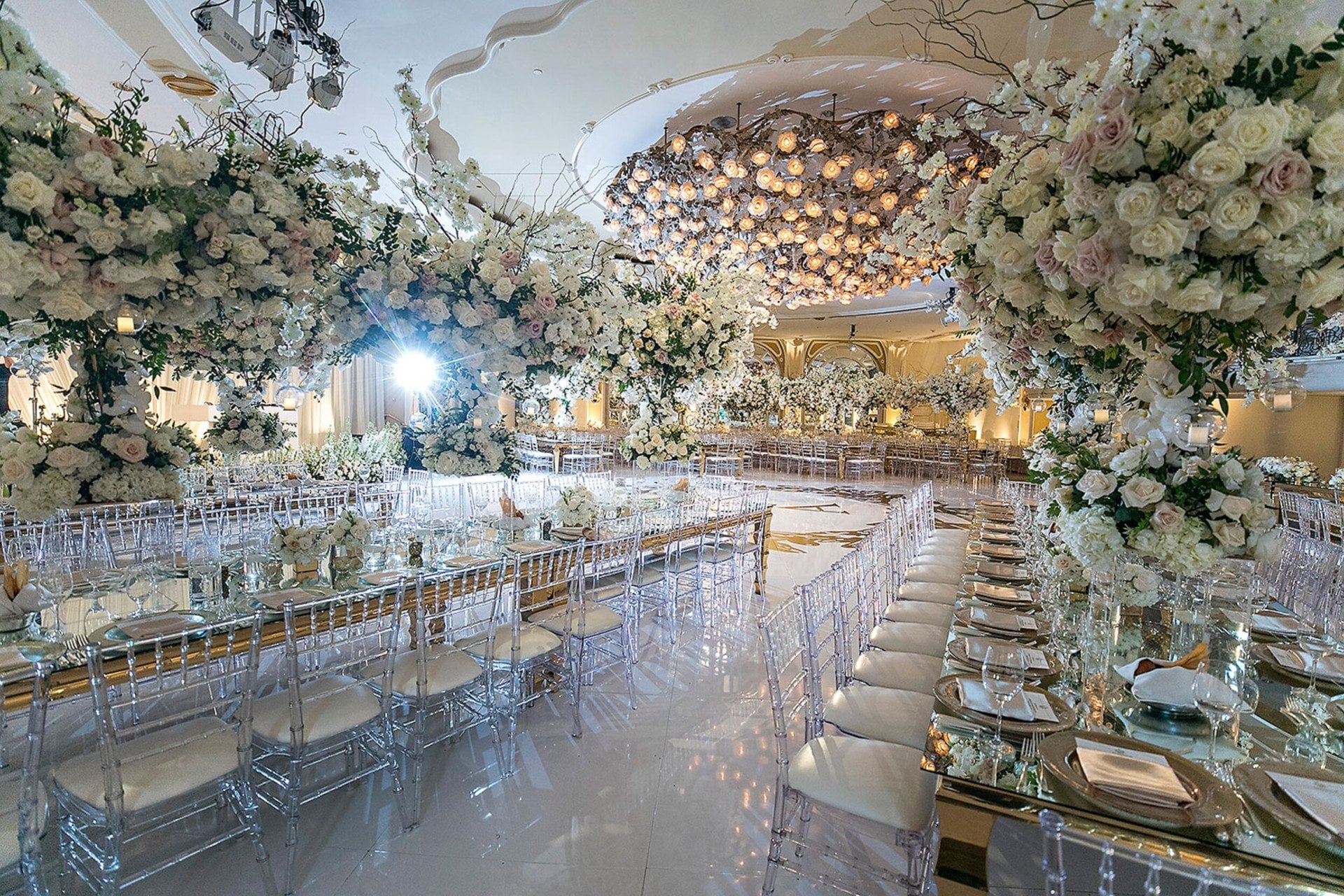 Crystal ballroom transformed with white dance floor and oversized white florals for wedding in Beverly Hills