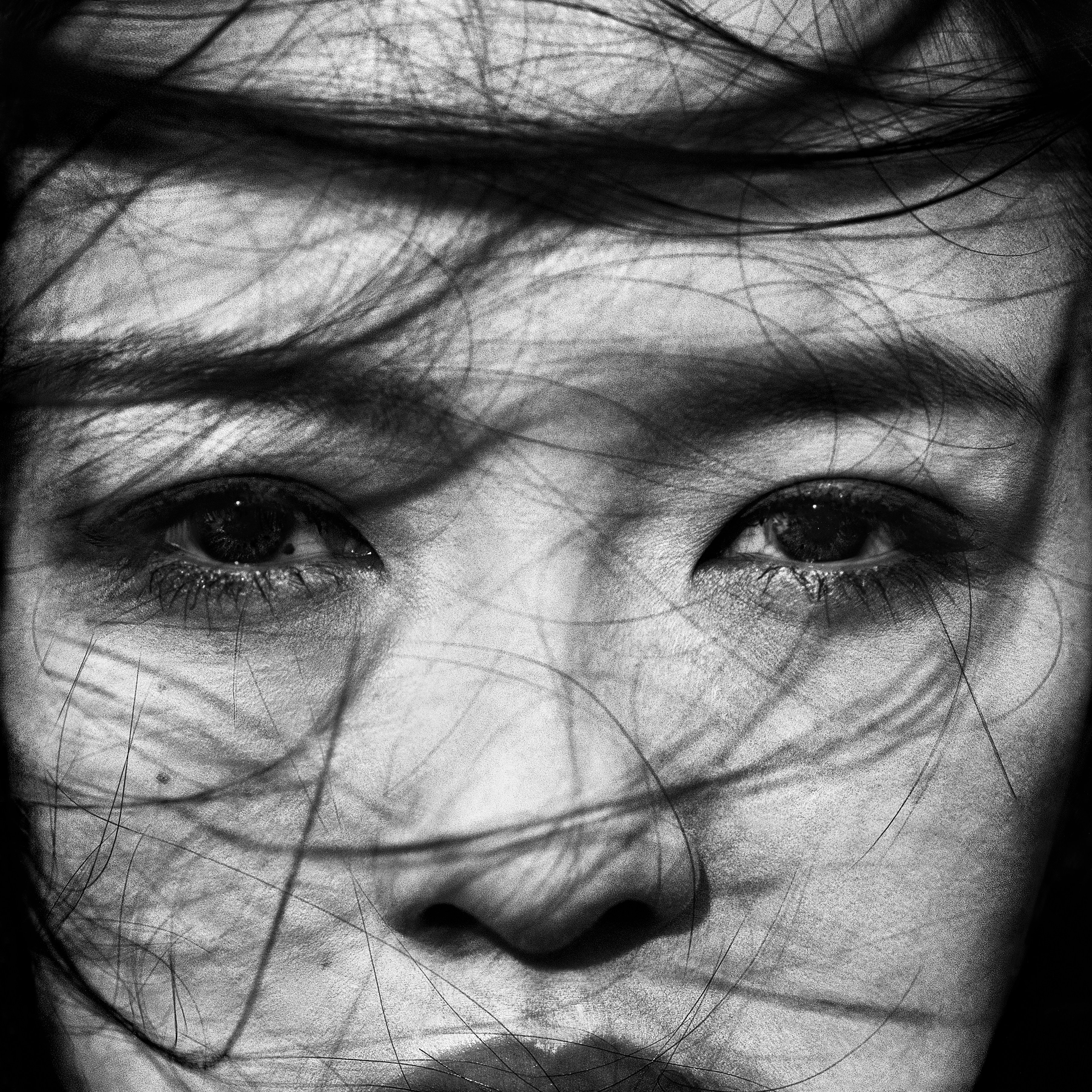 One of the photographs from photographer Max Cardelli’s series, an intense close-up portrait black and white. 