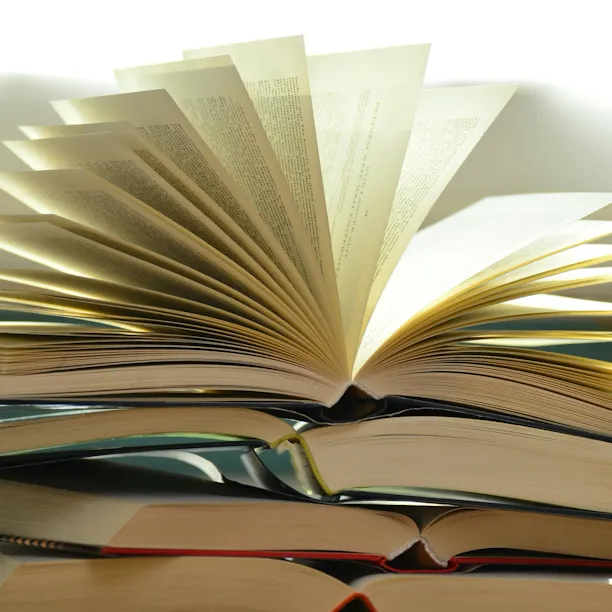 Close up view of stacked books on desk