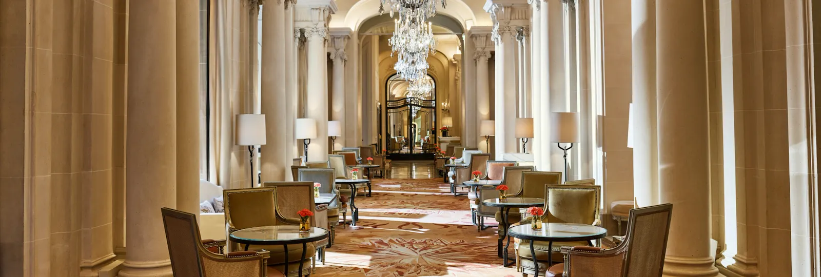 La Galerie dining room corridor with its chandeliers and set up tables, at Hotel Plaza Athénée, Paris