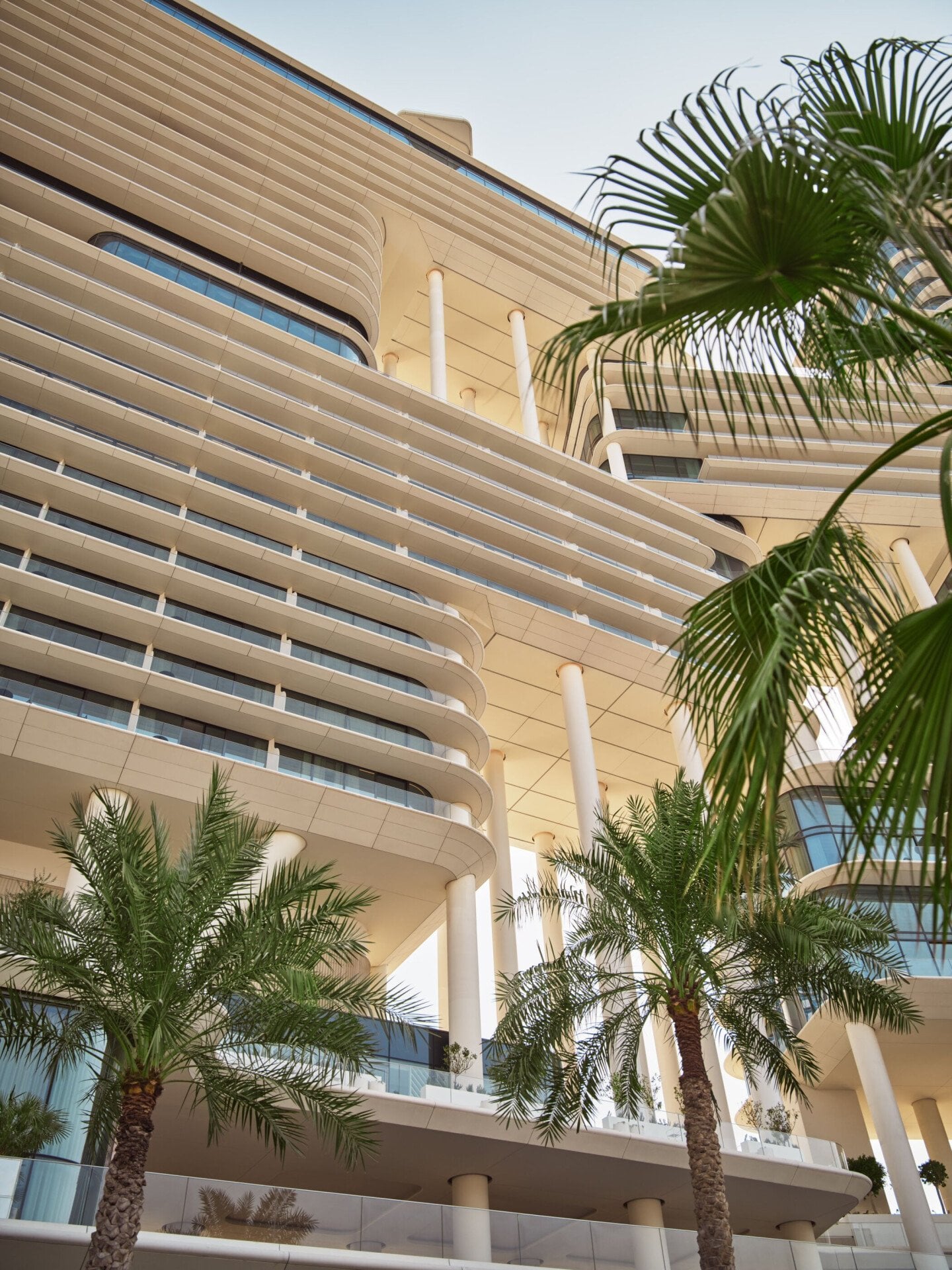 Architectural exterior detail with palm trees of The Lana hotel, Dubai