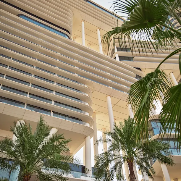 Architectural exterior detail with palm trees of The Lana hotel, Dubai