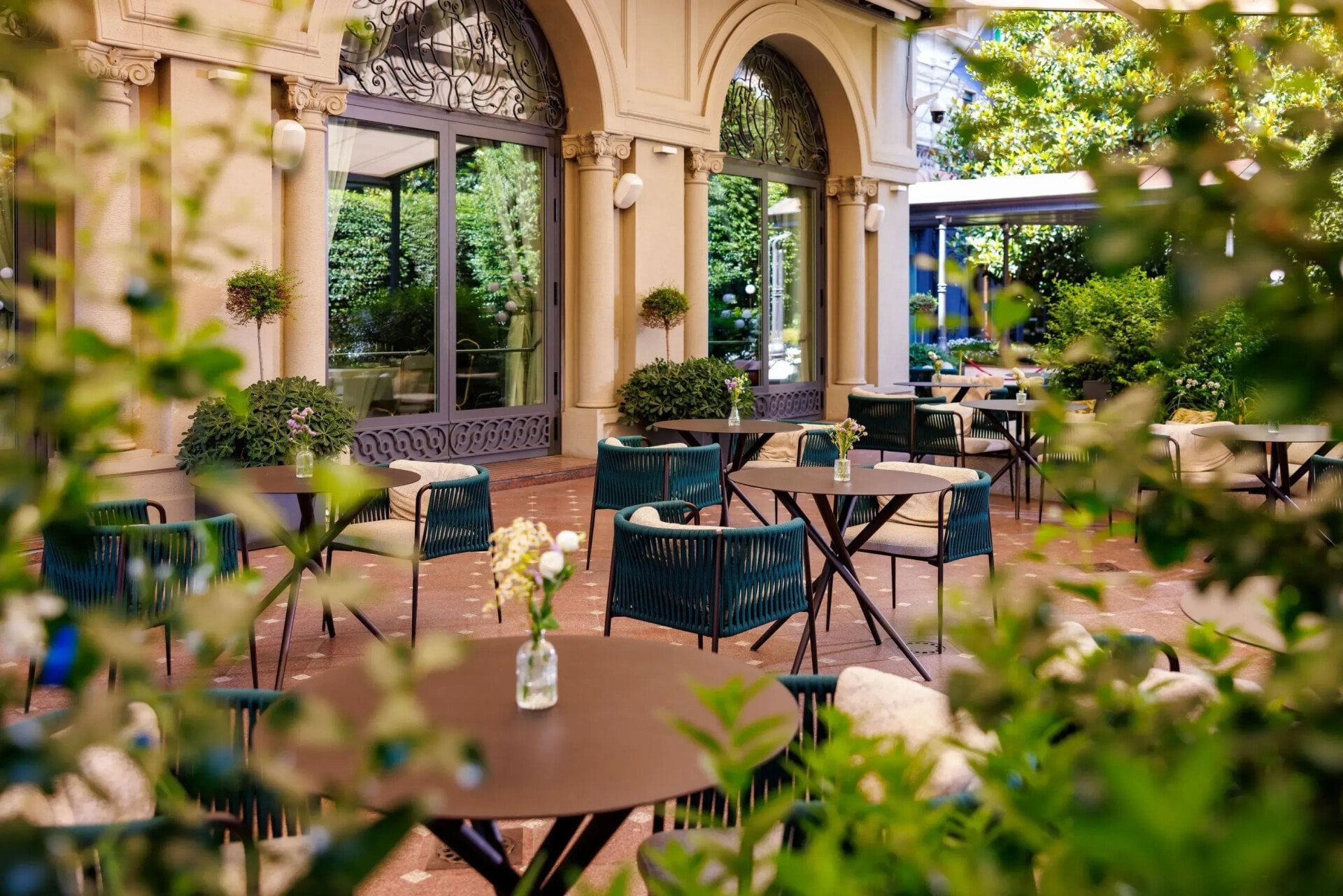 Veranda garden with tables decorated with colorful flower pots