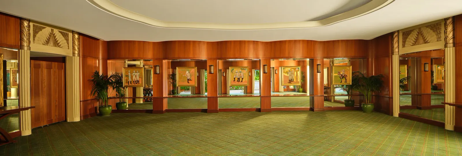 Empty conference room with windows, plants, and green carpet, calm and professional atmosphere