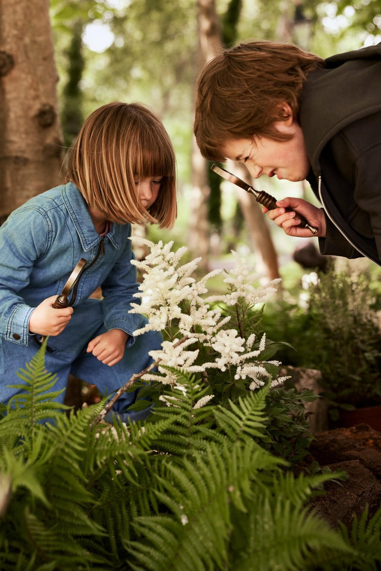 Children playing with flowers and wild flowers in the Coworth Park Grounds