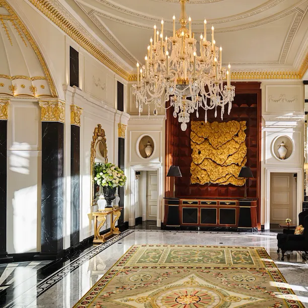 The Dorchester Lobby with reception desk and concierge desk in afternoon sunlight