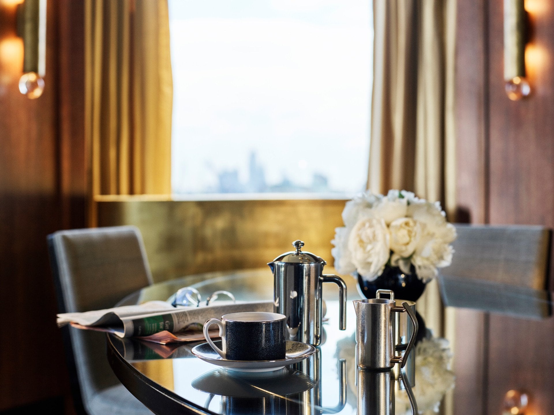 Penthouse Suite-living room_ beautiful daylight, coffee and newspaper on the dining table 