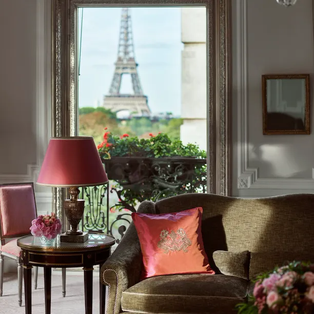 Haute Couture Suite Living room with balcony doors open to view of Eiffel Tower