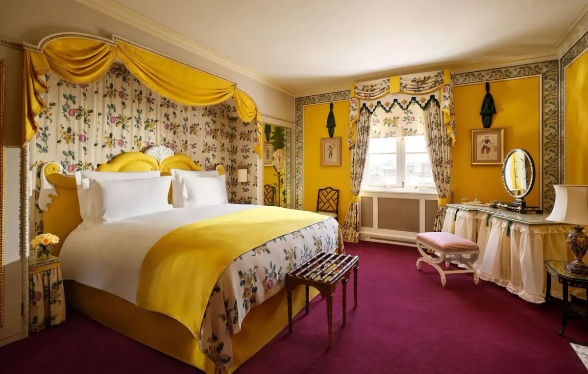 A bedroom in warm yellow hues and matching patterns