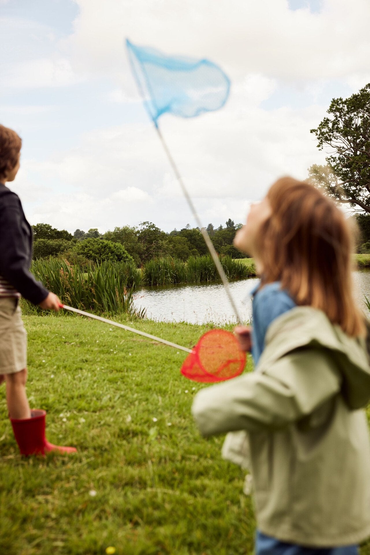Children playing with flowers and wild flowers in the Coworth Park Grounds