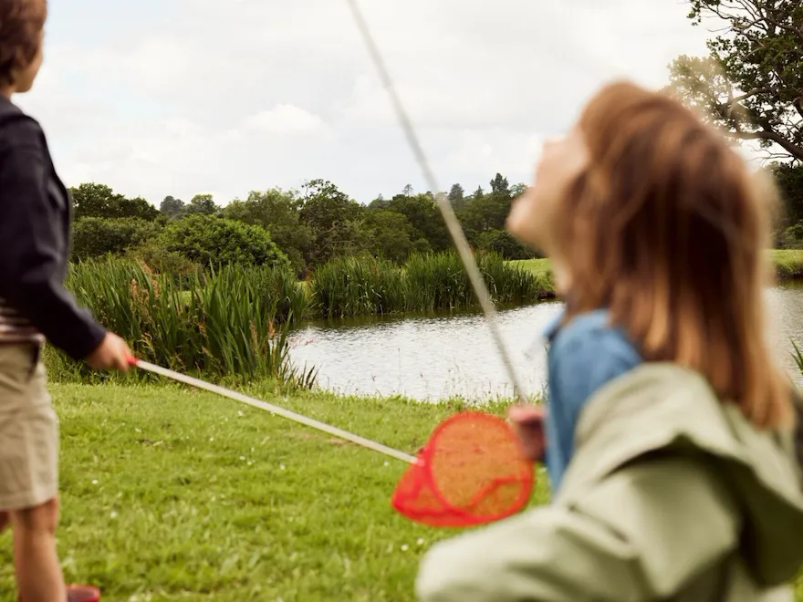Children playing with flowers and wild flowers in the Coworth Park Grounds