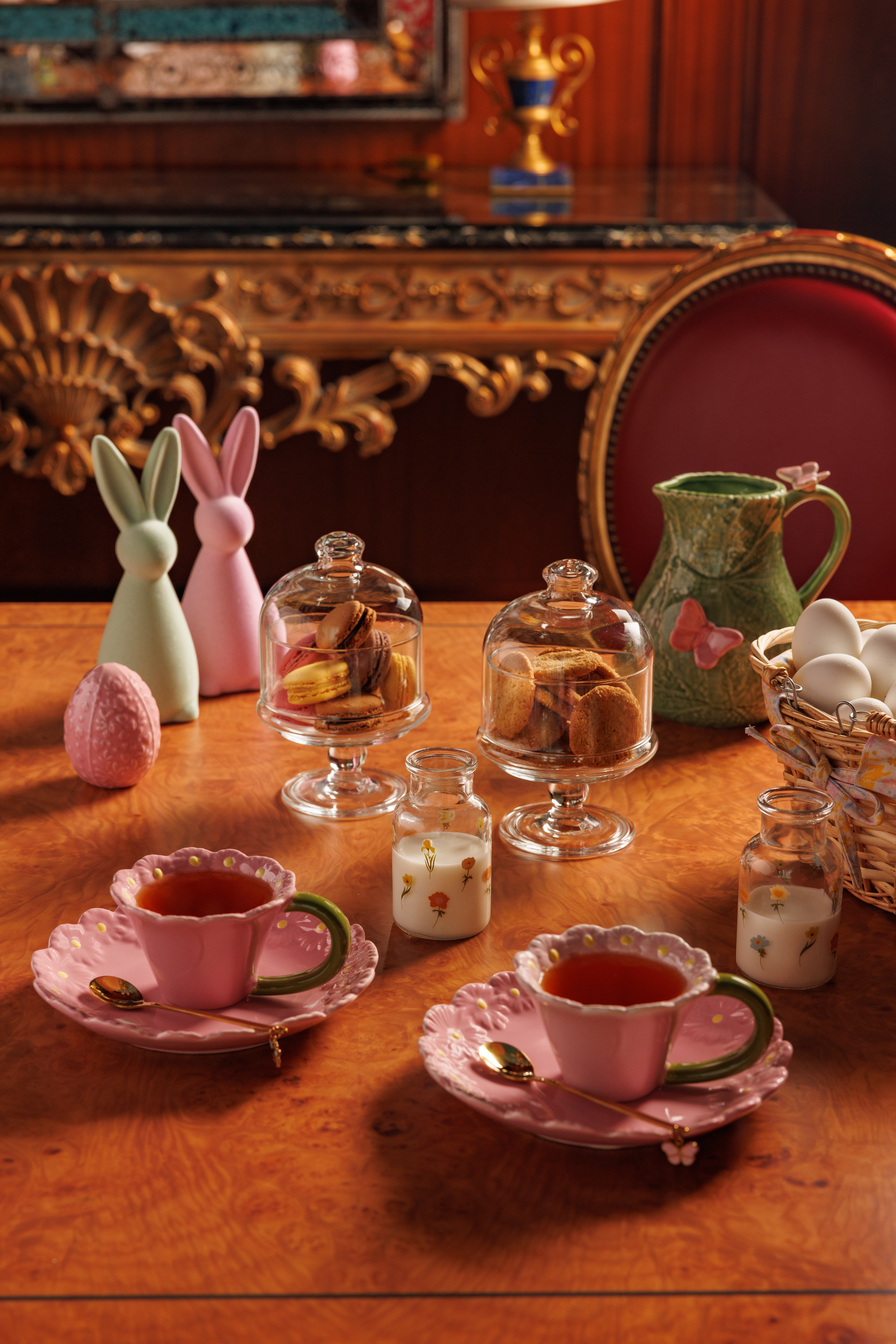Wonderland-themed tea party table decor featuring colorful teacups, teapots, and pastries.
