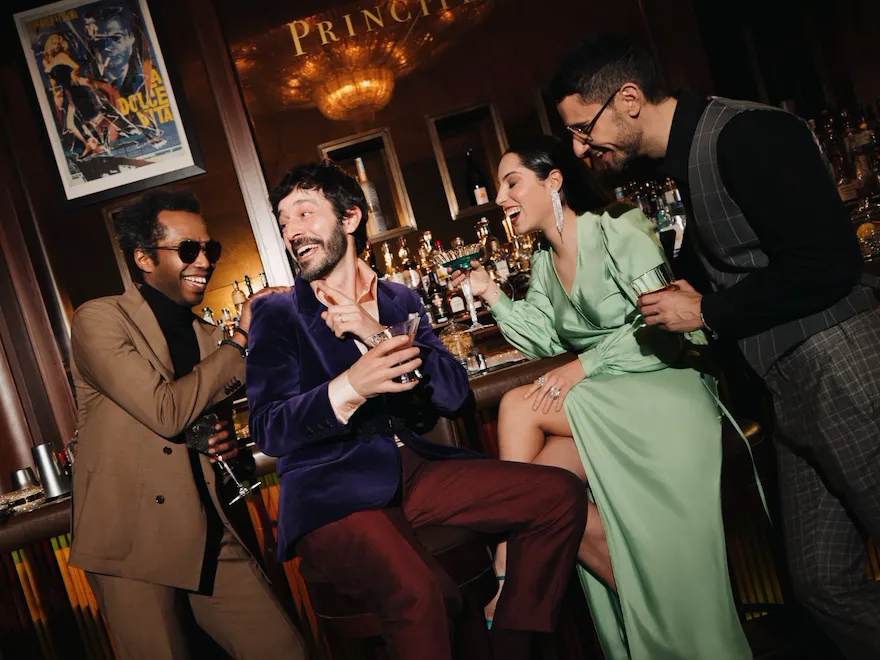 A group of people celebrating and drinking cocktails at Principe Bar