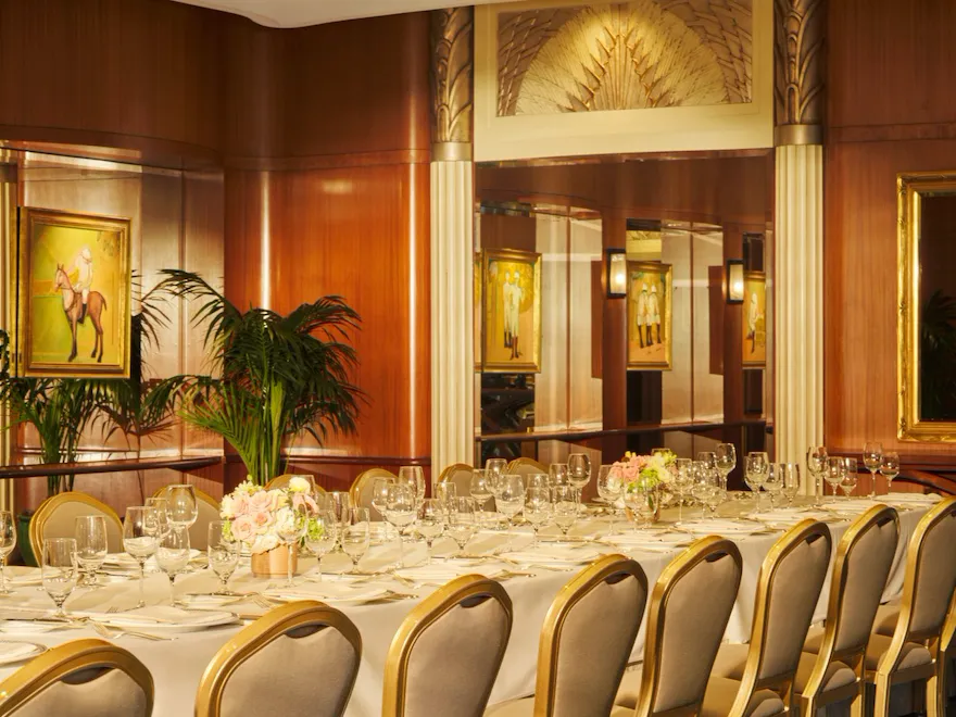 Elegant banquet table set for a formal event in a luxurious decorated room