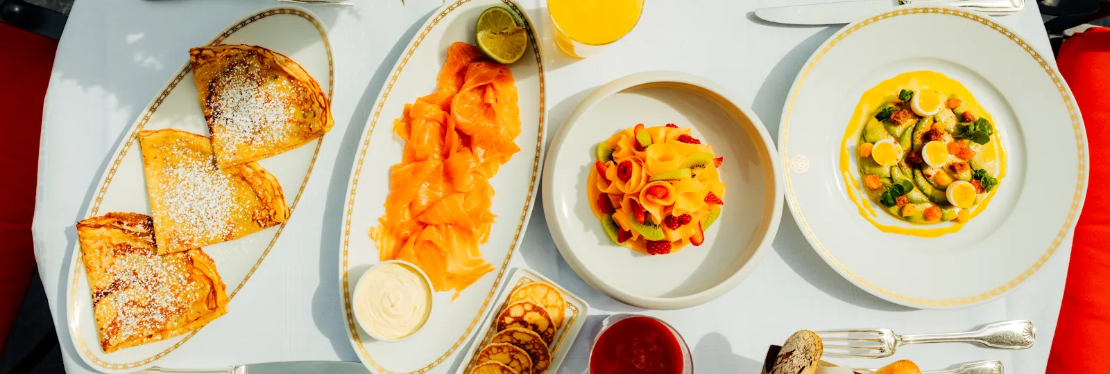 Breakfast, savoury and sweet treats on a white table at Plaza Athénée