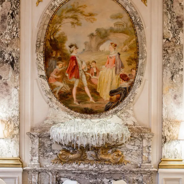 Retrato da escultura mural de vidro com mesas postas de cada lado no Restaurante Le Meurice Alain Ducasse, no Le Meurice, Paris.