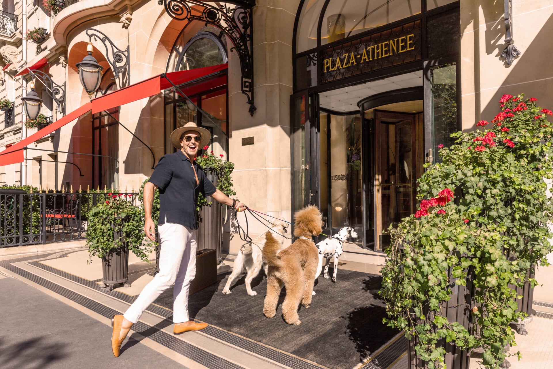 Gray Malin's Portrait at Hôtel Plaza Athénée - Walking with dogs in the front entrance