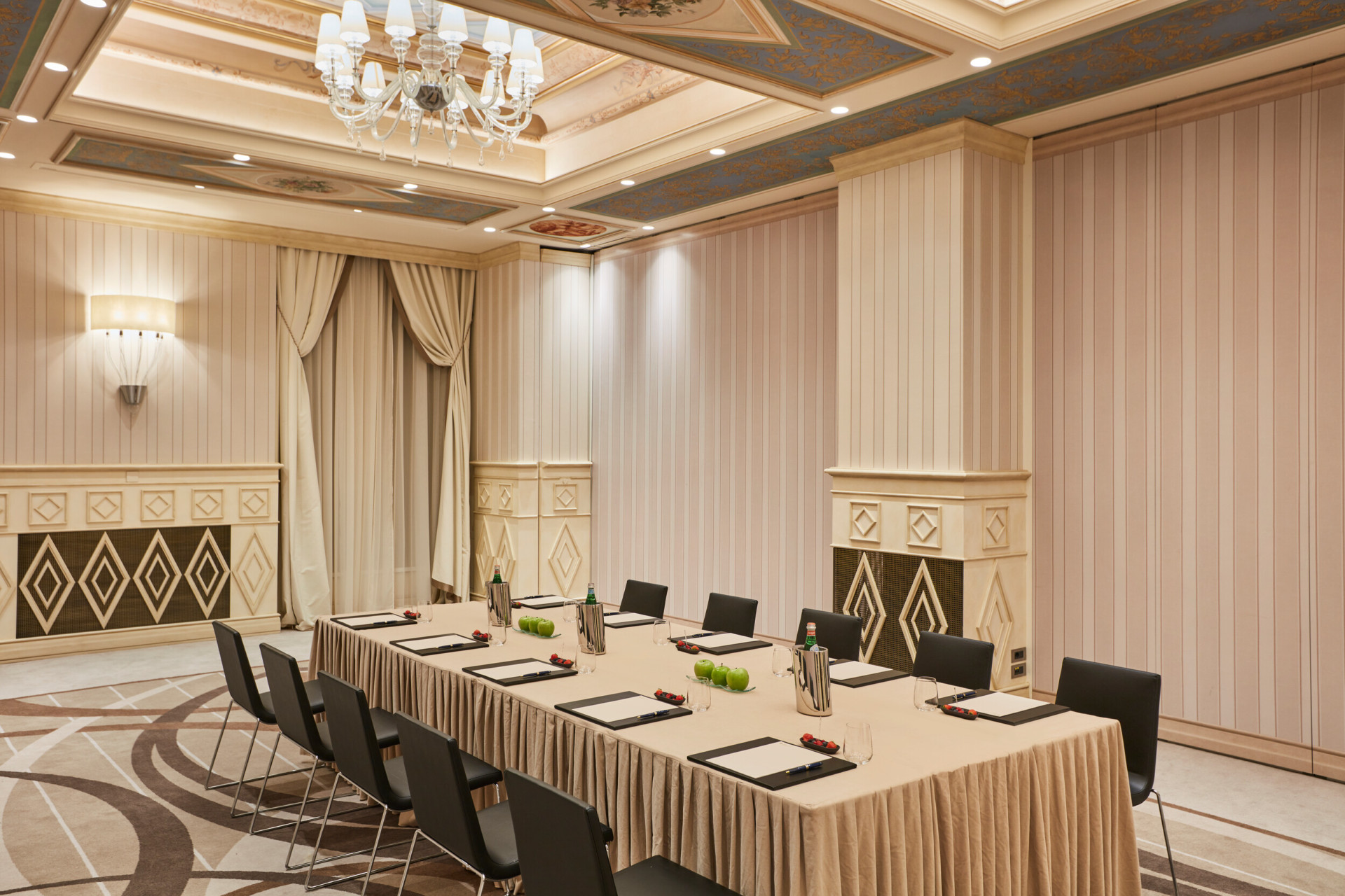 'Galilei' meeting room with a table set up with notepads, waters and fruits