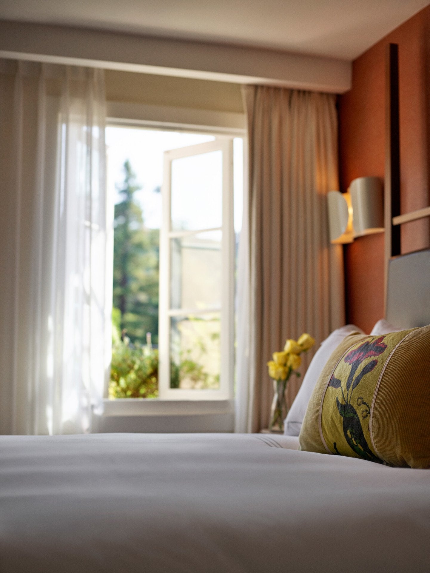 Detail shot of the surface of a bed with a window in view from a Canyon Suite at Hotel Bel-Air. 