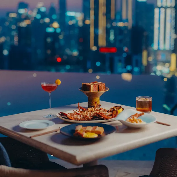 High Society's Japanese inspired dishes on a table in front of the pool