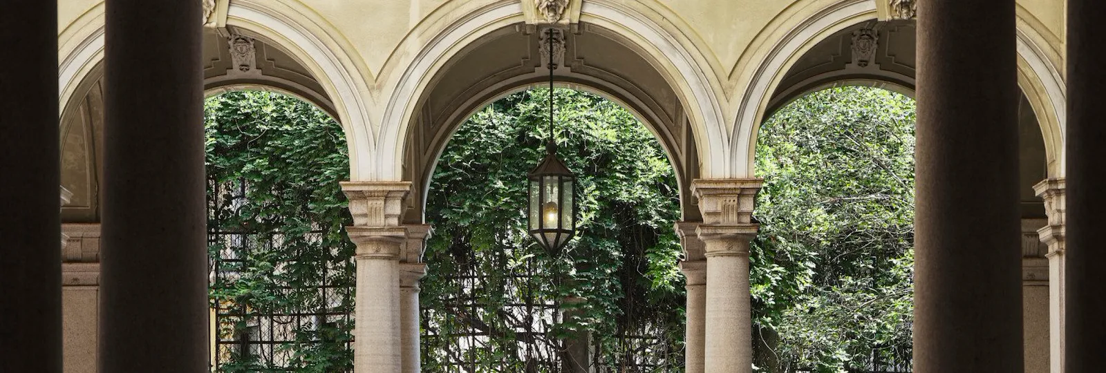 View of a Brera courtyard with arches and plants