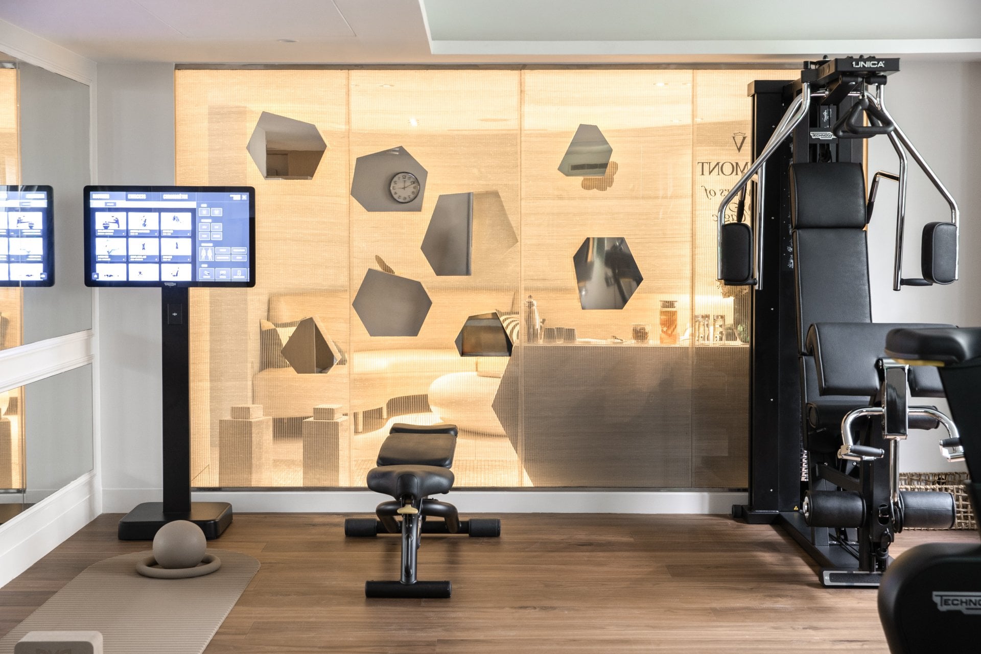 Modern gym with equipment and a glass wall, ready for workout in a bright setting
