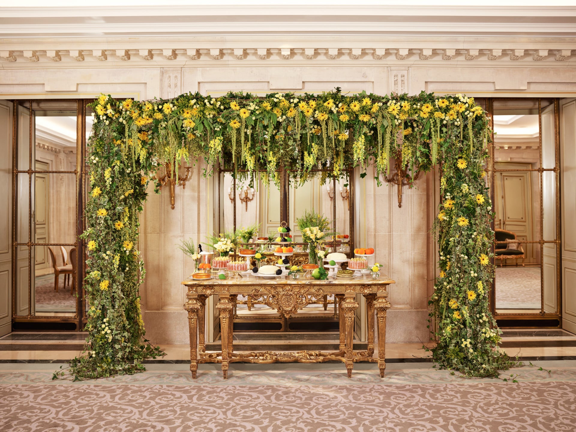 Pastry table for private dinner in Salon Tuileries, with green and yellow floral arch, at Le Meurice, Paris - Dorchester Collection