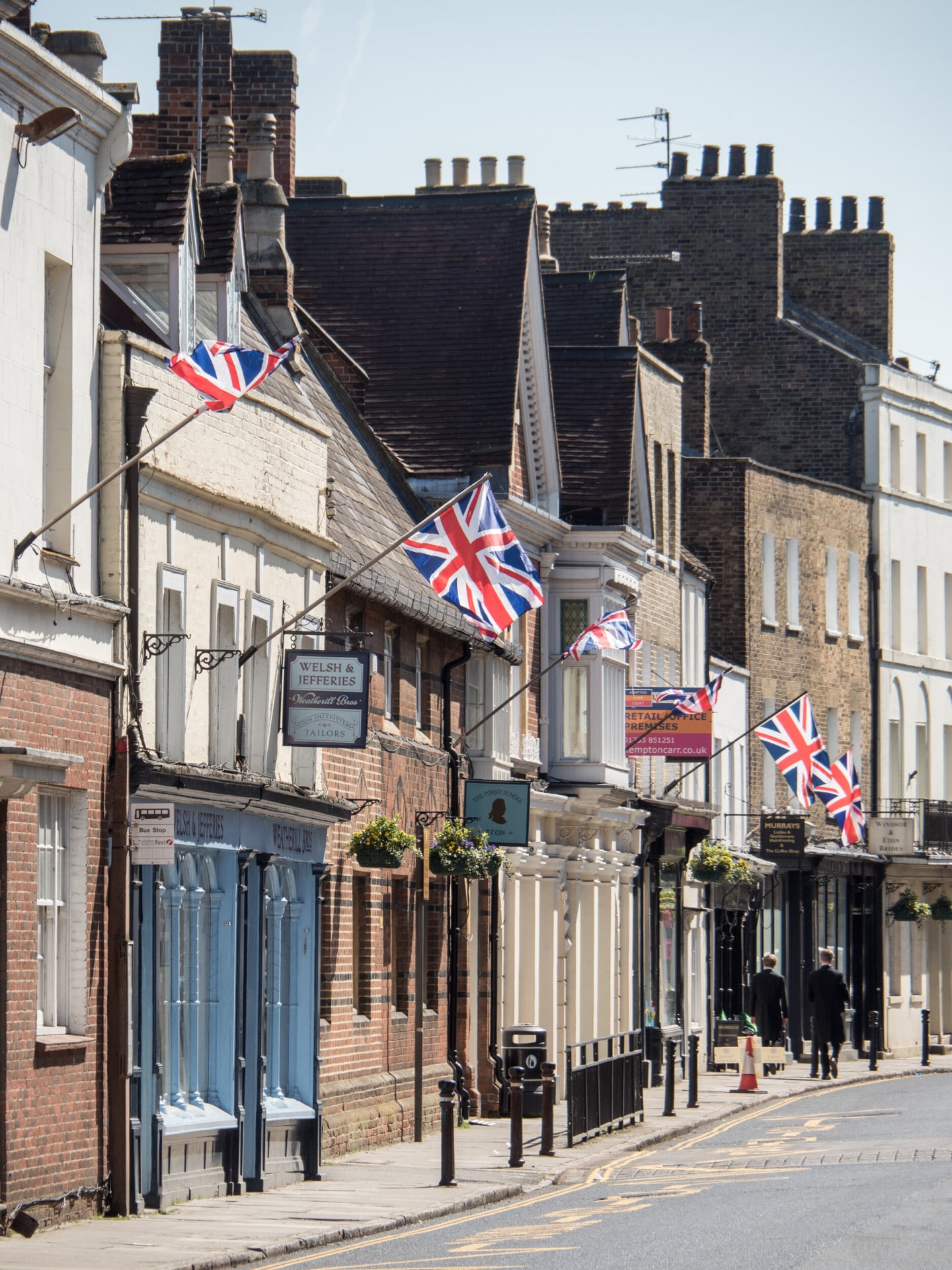 Line of shops on the side of a road in sunny Windsor town centre,Berkshire