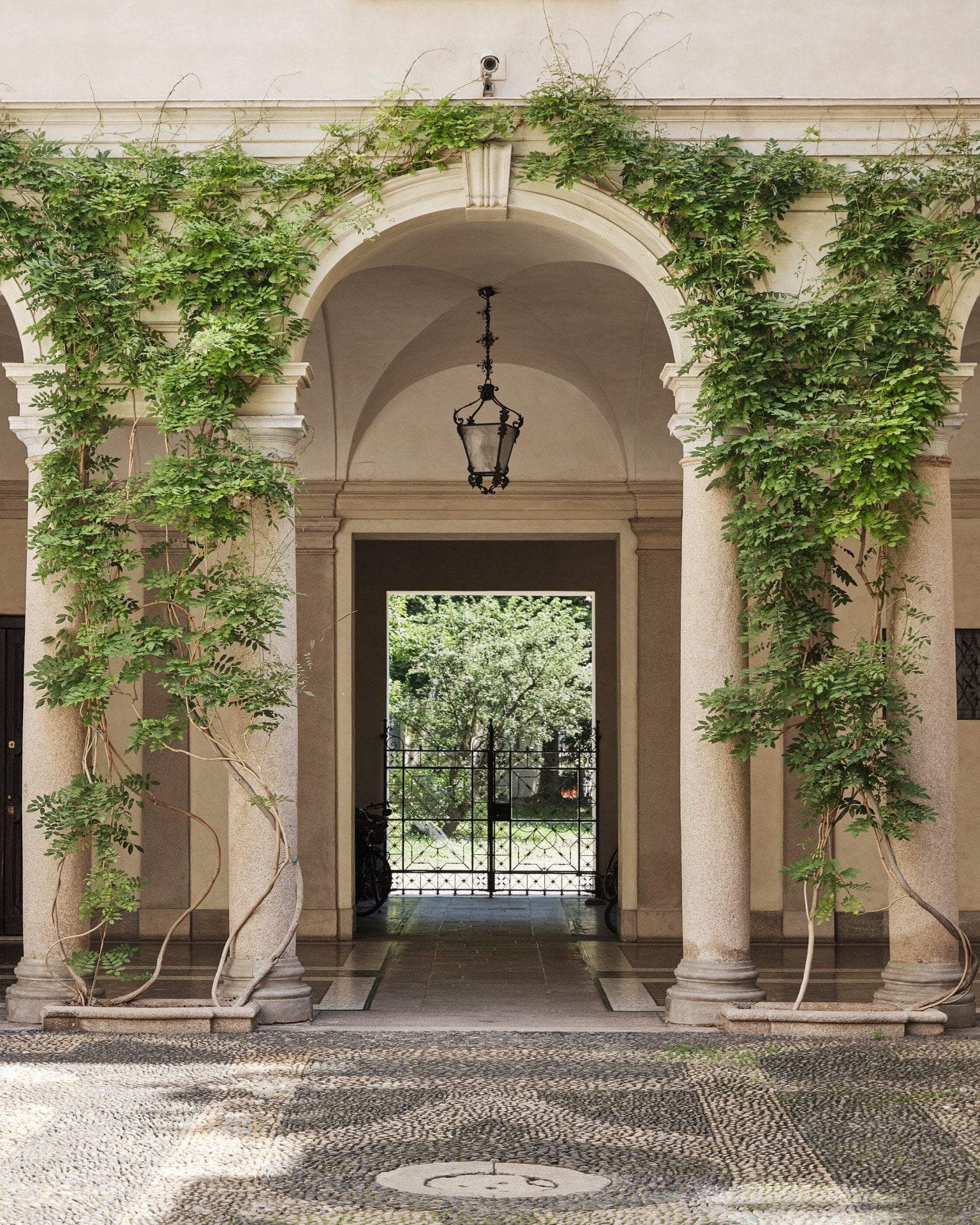 View of a Brera courtyard with arches and plants 