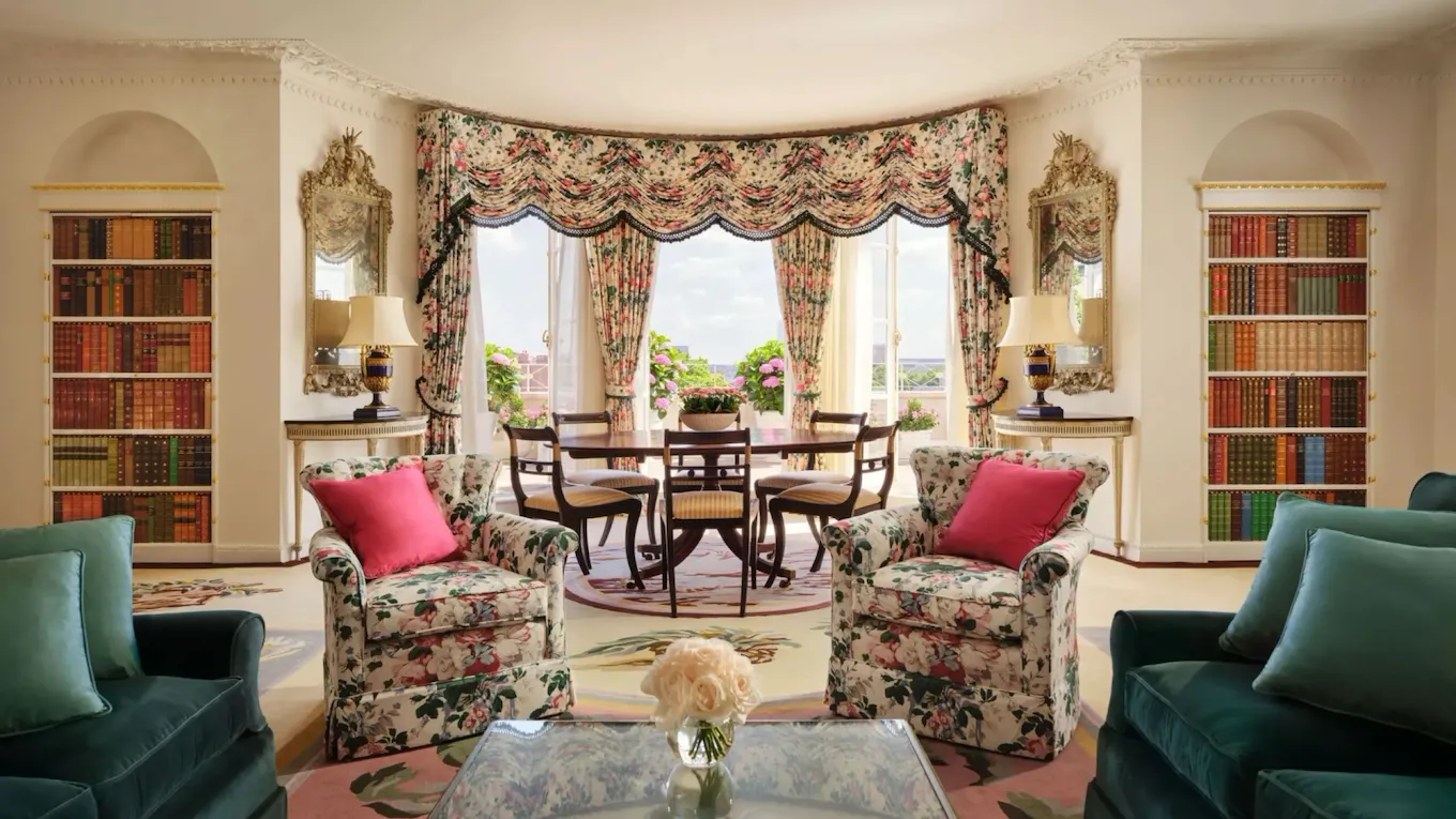 An attractive suite with a dining table and comfortable furnishings